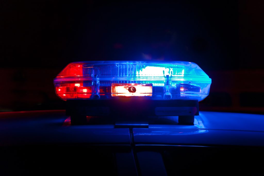police car blue lights red lights domestic violence michigan